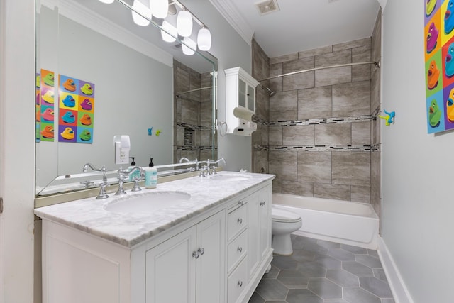 full bathroom with tiled shower / bath, vanity, toilet, crown molding, and tile patterned floors