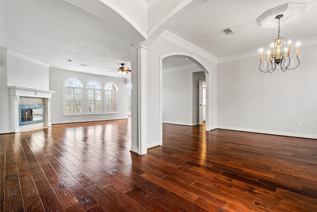 unfurnished living room featuring crown molding, ceiling fan with notable chandelier, and dark hardwood / wood-style flooring