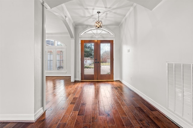 foyer entrance with crown molding, wood-type flooring, and french doors