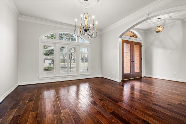 interior space with dark hardwood / wood-style flooring, crown molding, a chandelier, and french doors