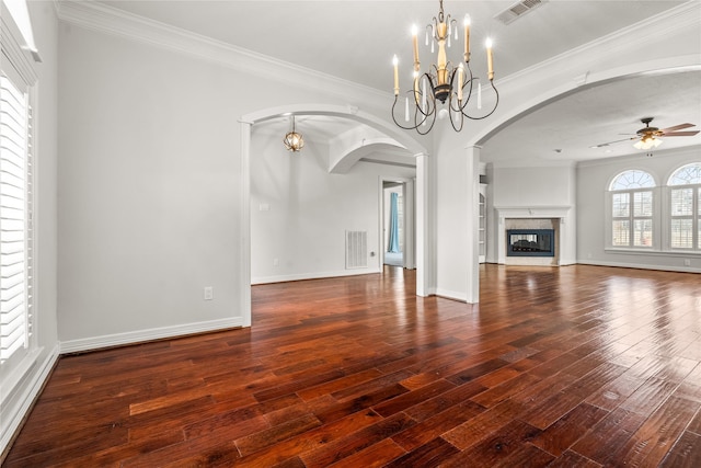 unfurnished living room with a premium fireplace, ornamental molding, ceiling fan with notable chandelier, and dark hardwood / wood-style floors