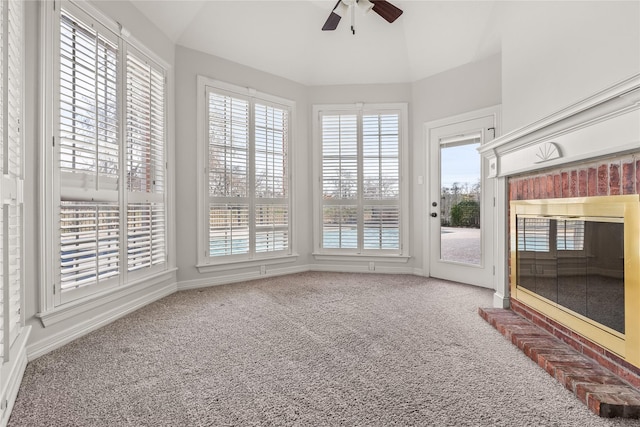 unfurnished sunroom with ceiling fan and vaulted ceiling