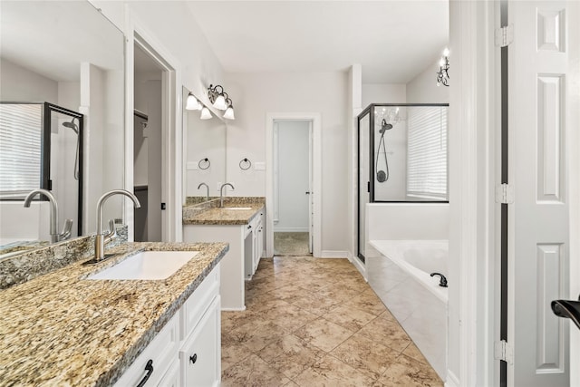 bathroom featuring vanity, shower with separate bathtub, and a wealth of natural light