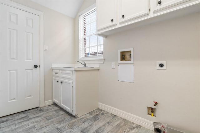 laundry area with cabinets, sink, hookup for a washing machine, and electric dryer hookup