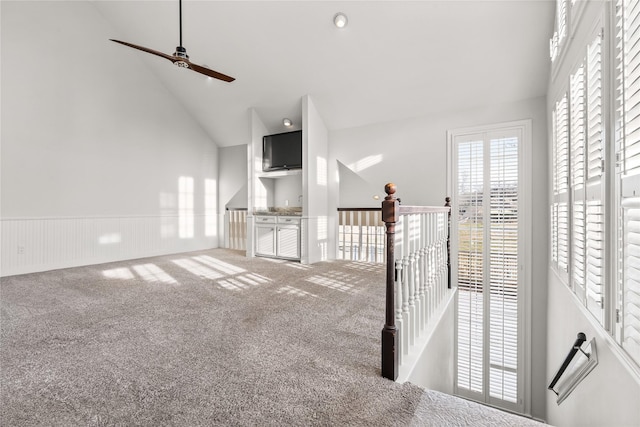 interior space with carpet floors and high vaulted ceiling