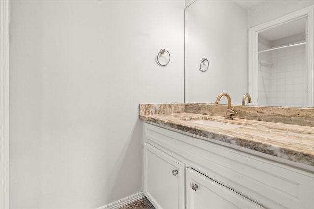 bathroom with vanity and a shower