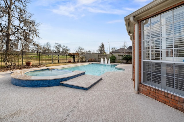 view of swimming pool with an in ground hot tub and a patio