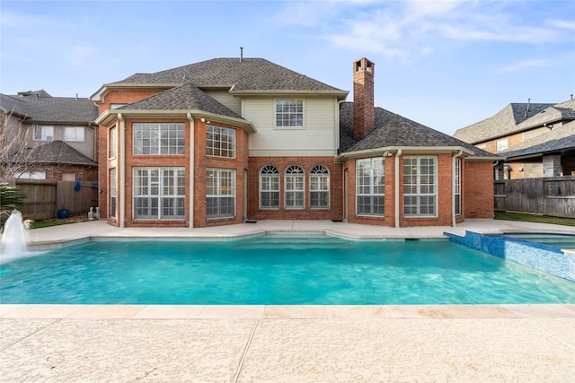 view of swimming pool featuring an in ground hot tub