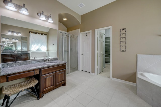 bathroom featuring tile patterned floors, vanity, shower with separate bathtub, and lofted ceiling