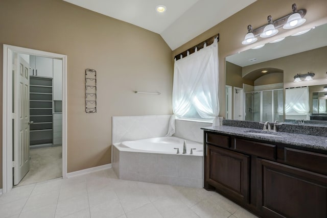 bathroom with lofted ceiling, vanity, tile patterned floors, and plus walk in shower