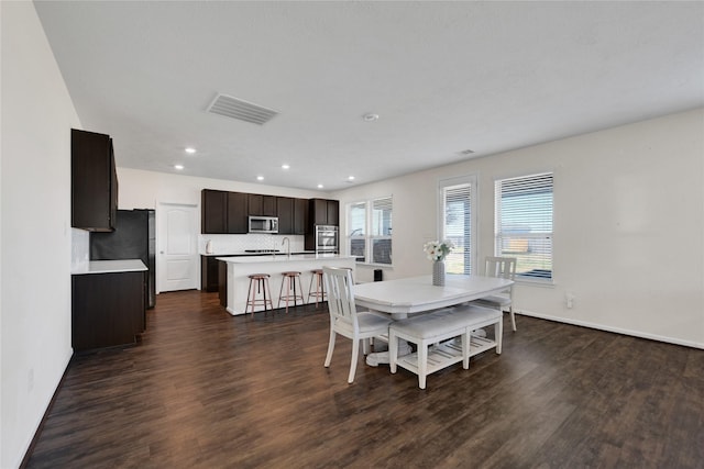 dining room featuring dark hardwood / wood-style flooring and sink