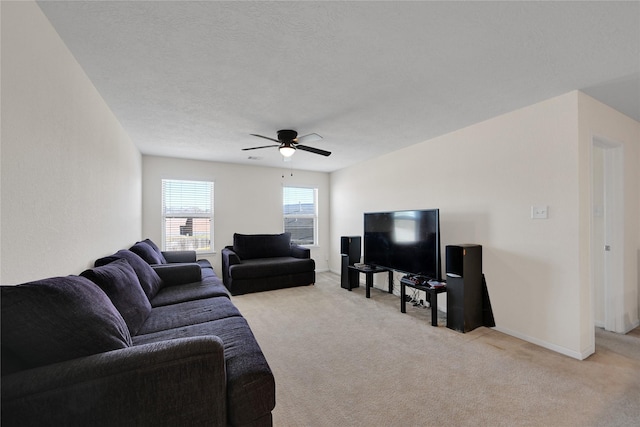 living room featuring light colored carpet, a textured ceiling, and ceiling fan