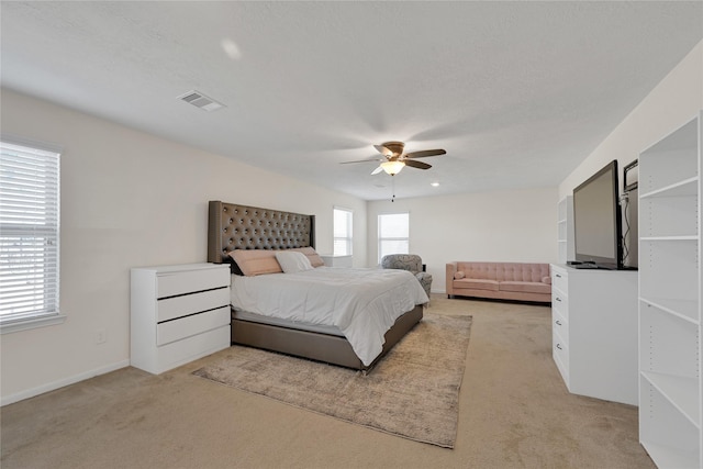 carpeted bedroom featuring a textured ceiling and ceiling fan