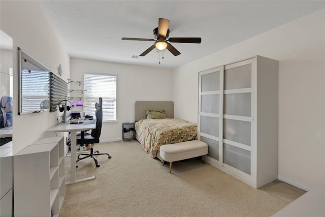 carpeted bedroom with ceiling fan