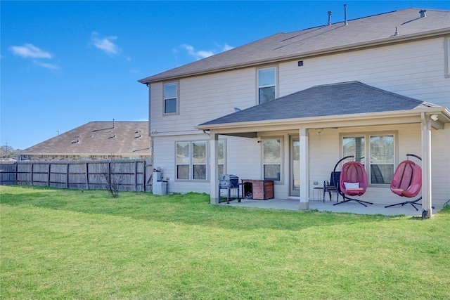 back of house with a lawn and a patio area