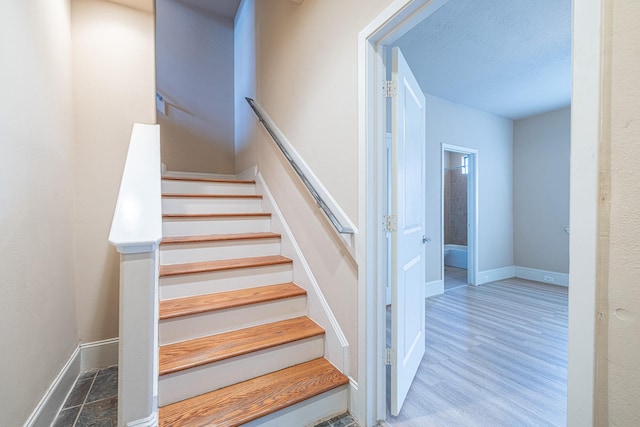 stairway with hardwood / wood-style flooring