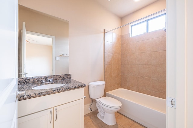 full bathroom featuring tiled shower / bath, tile patterned floors, toilet, and vanity