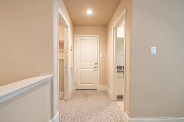 corridor with light colored carpet