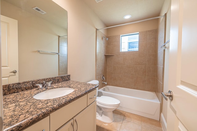 full bathroom with tiled shower / bath, vanity, tile patterned floors, and toilet