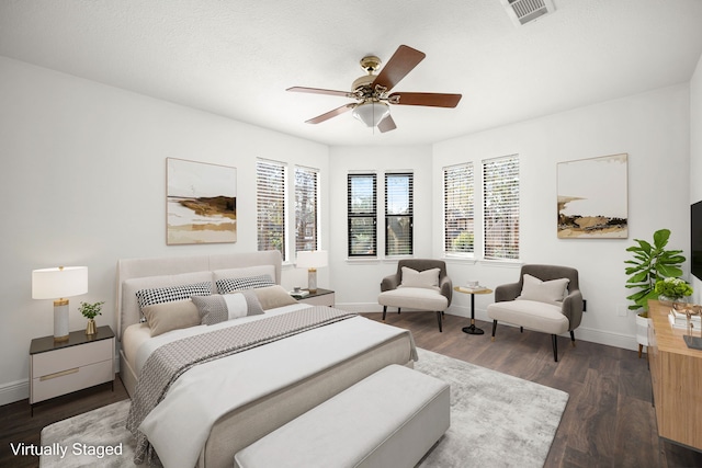 bedroom with dark hardwood / wood-style floors and ceiling fan