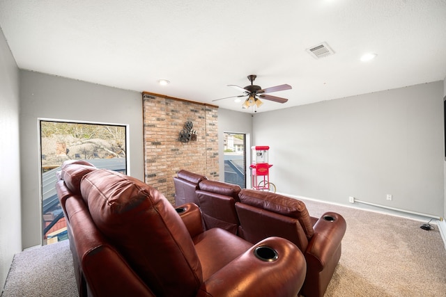 carpeted cinema featuring ceiling fan