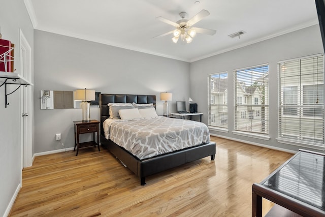 bedroom with ceiling fan, ornamental molding, and light hardwood / wood-style flooring