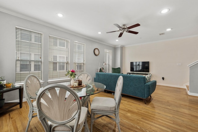 dining space with ceiling fan, ornamental molding, and light hardwood / wood-style flooring