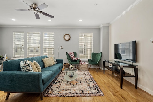 living room with crown molding, ceiling fan, and light wood-type flooring