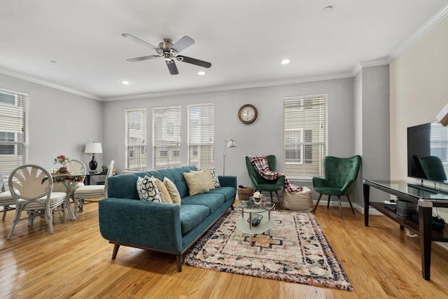 living room featuring crown molding, ceiling fan, and light wood-type flooring