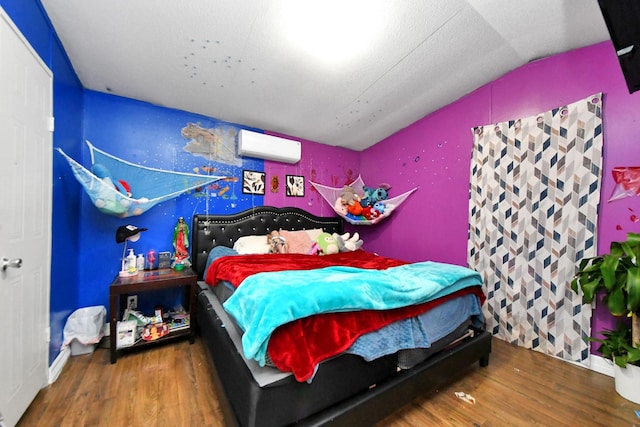 bedroom with vaulted ceiling, wood-type flooring, and an AC wall unit