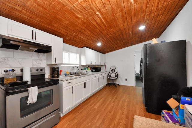 kitchen with black refrigerator, stainless steel electric stove, sink, and white cabinets