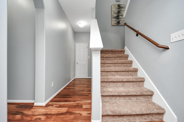 stairs featuring hardwood / wood-style floors