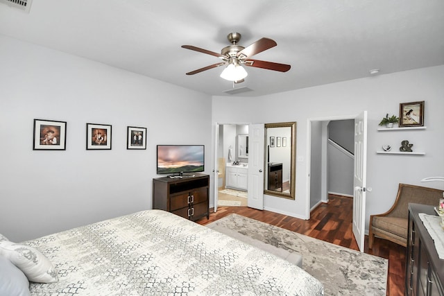 bedroom with ensuite bathroom, dark hardwood / wood-style floors, and ceiling fan