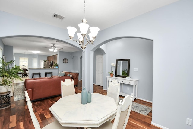 dining room featuring wood-type flooring and ceiling fan with notable chandelier