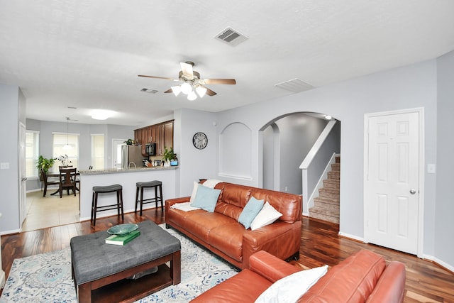 living room featuring ceiling fan and light hardwood / wood-style floors