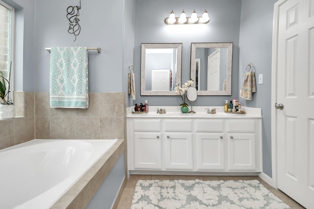 bathroom featuring vanity, tiled bath, and tile patterned flooring