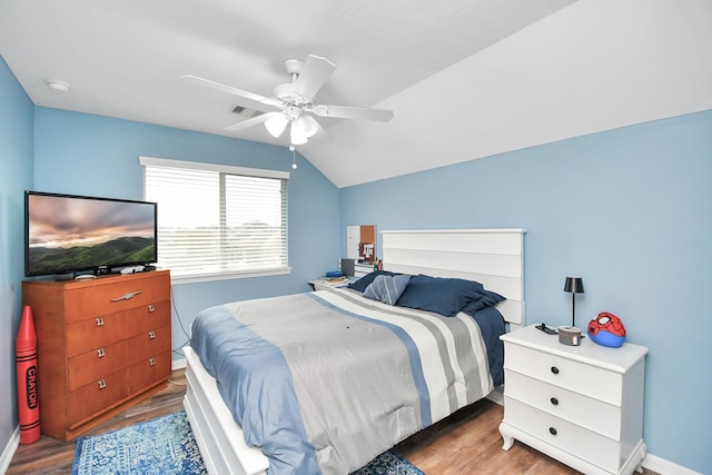 bedroom with vaulted ceiling, hardwood / wood-style floors, and ceiling fan