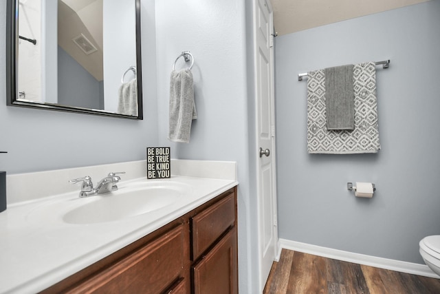 bathroom featuring hardwood / wood-style flooring, vanity, and toilet