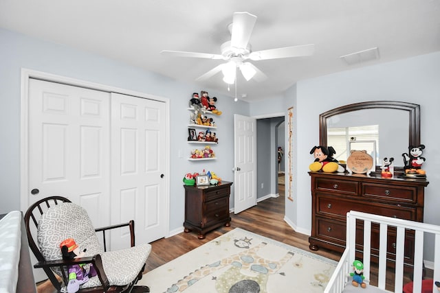 bedroom with ceiling fan, dark hardwood / wood-style flooring, and a closet