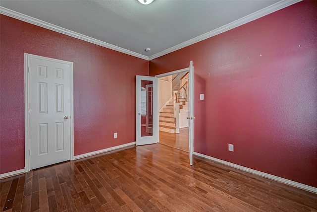 unfurnished bedroom with hardwood / wood-style flooring, ornamental molding, and french doors