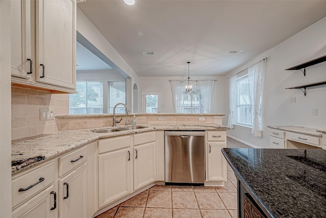 kitchen featuring stainless steel dishwasher, a sink, open shelves, light stone counters, and healthy amount of natural light