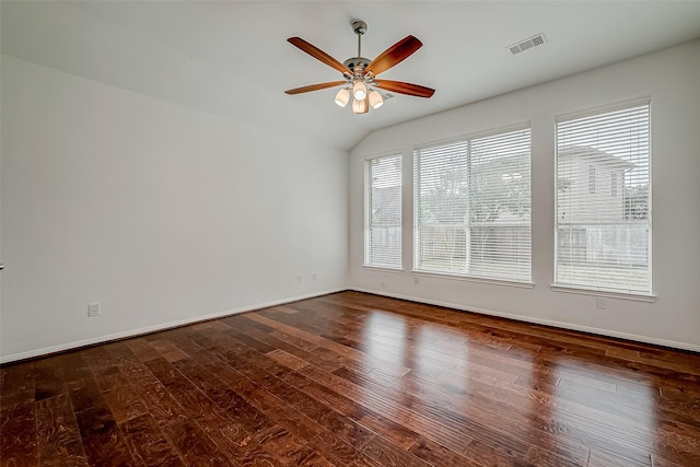spare room featuring ceiling fan, dark wood-style floors, lofted ceiling, and baseboards