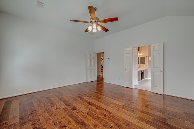 unfurnished room featuring ceiling fan, wood finished floors, and lofted ceiling