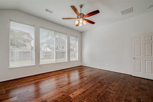 unfurnished room featuring ceiling fan, dark wood-style floors, baseboards, and vaulted ceiling
