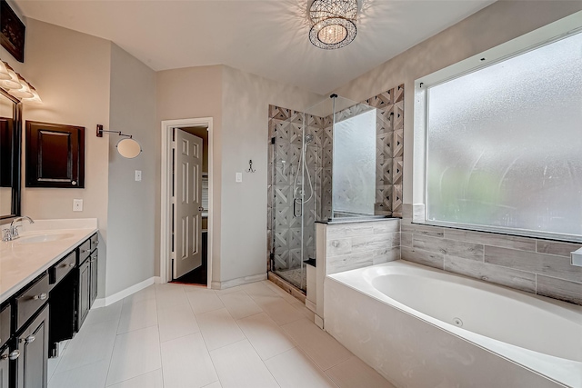full bathroom featuring a bath, a shower stall, baseboards, vanity, and tile patterned floors