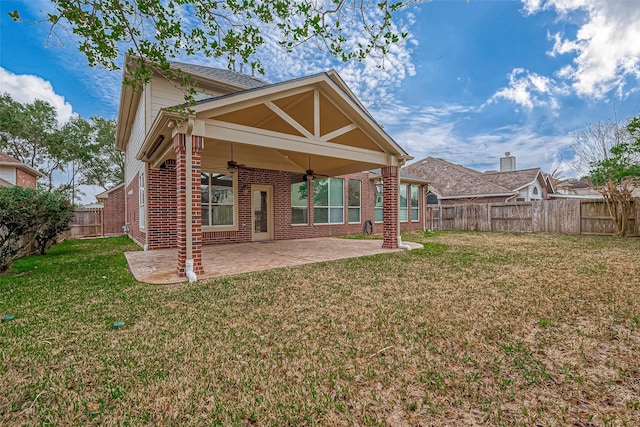 back of property featuring a yard, a patio area, and ceiling fan