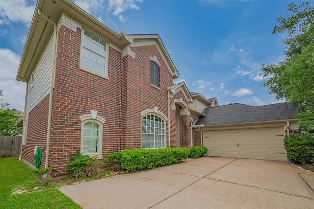 view of front of home featuring brick siding, driveway, and an attached garage