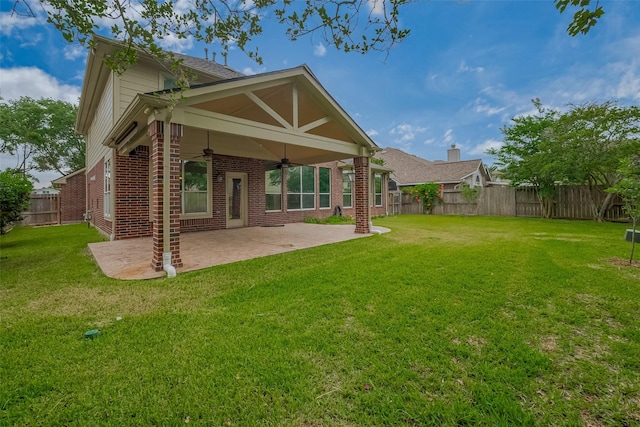 back of property with a ceiling fan, brick siding, and a patio area