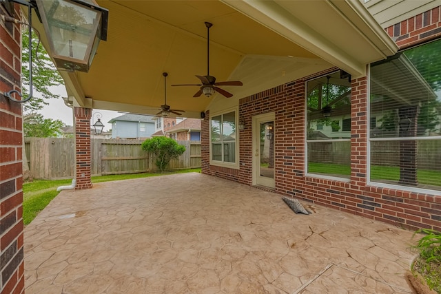 view of patio / terrace featuring fence and ceiling fan