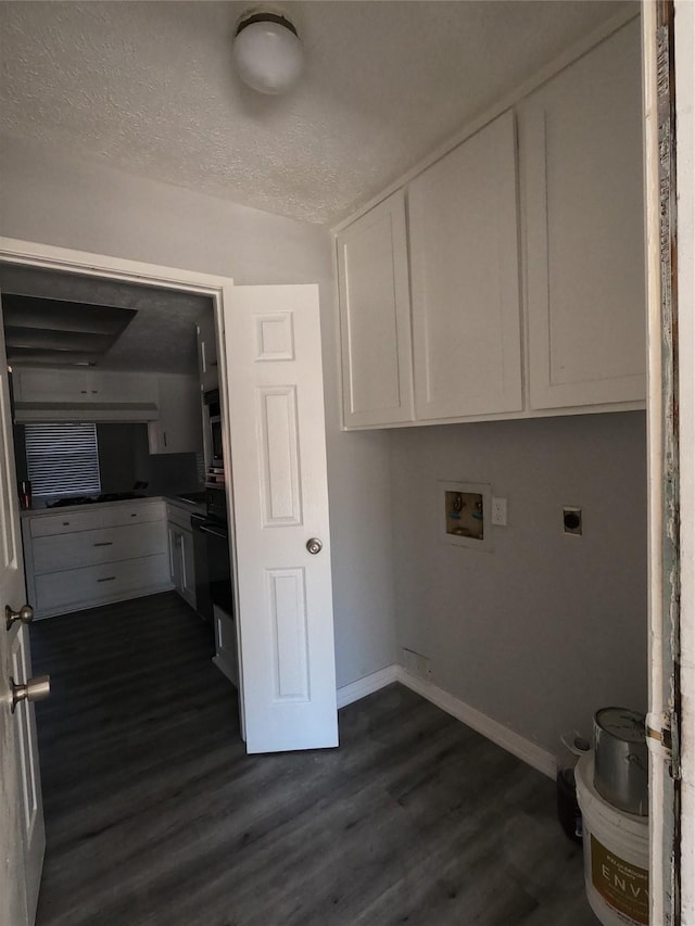 laundry area featuring cabinets, washer hookup, electric dryer hookup, dark wood-type flooring, and a textured ceiling